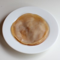 A dried out SCOBY Kombucha Mushroom rests on a plate, ready for other uses.