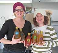 Vanessa and Alla of NessAlla Kombucha in Madison Wisconsin proudly hold cold bottles of their entire NessAlla Kombucha line.