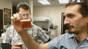 John Laffler of Goose Island Brewery examines a glass of Fleur, the Kombucha Beer