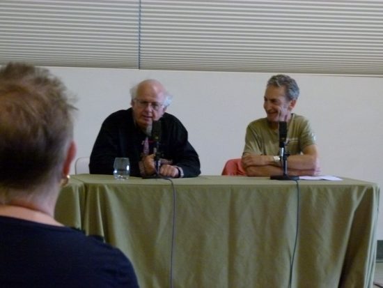 Event Founder Michael Stusser listens to Charlie Bamforth's presentation