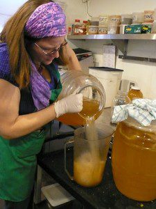 Hannah Crum, Master Kombucha Brewer for Leaf Organics - Pouring Kombucha