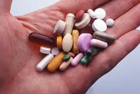 a hand full of vitamin pills